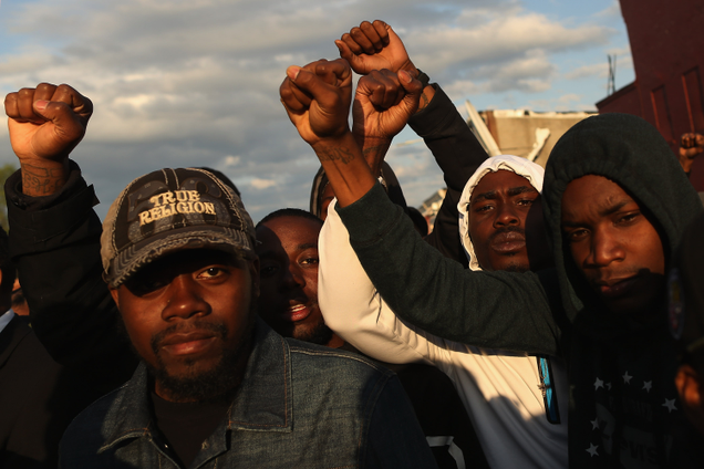 Demonstrators put their fists in the air as a sign of “black power” during a protest against police brutality and the death of Freddie Gray outside a police station in Baltimore on April 22, 2015. (Chip Somodevilla/Getty Images)